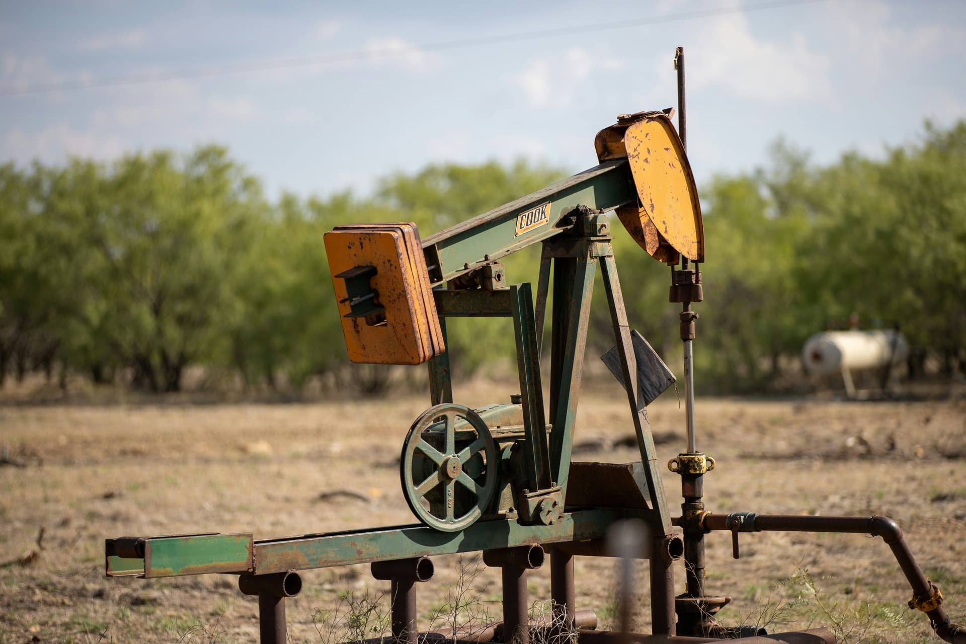 Ranch water pump equipment in a dry Texas pasture used to access groundwater for livestock and land operations