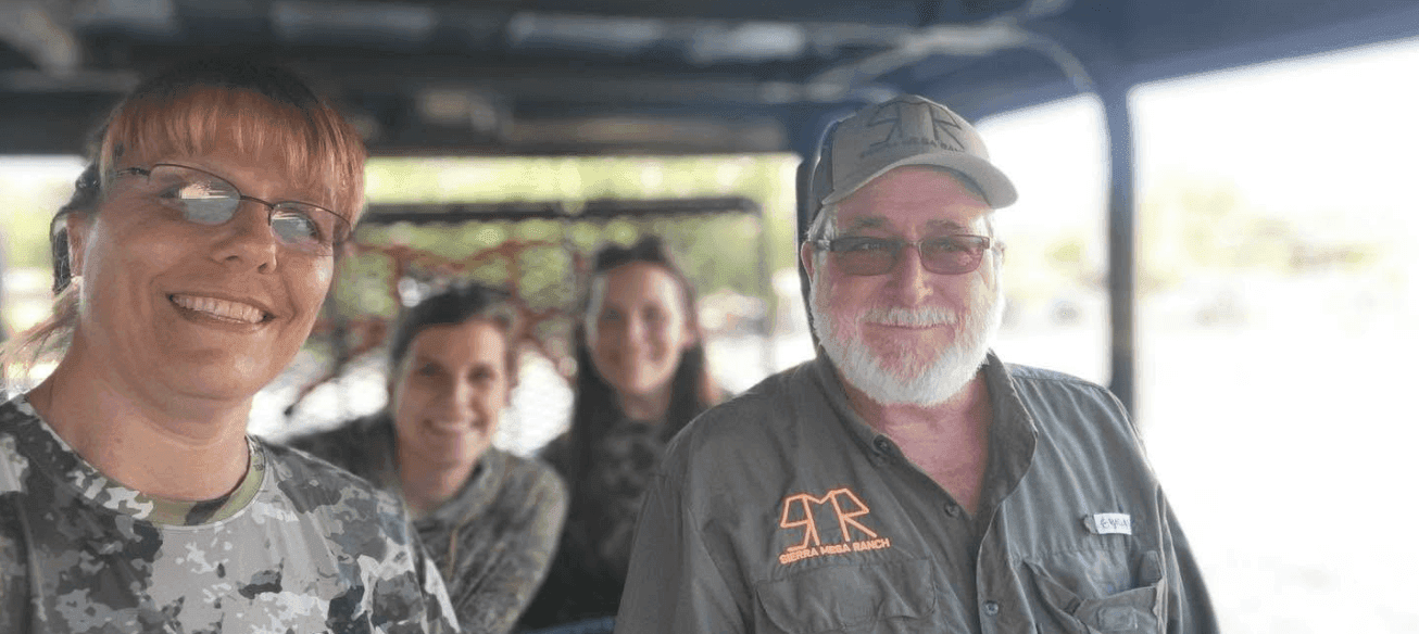 Group of women and their guide smiling in a safari-style hunting vehicle at Sierra Mesa Ranch in Texas