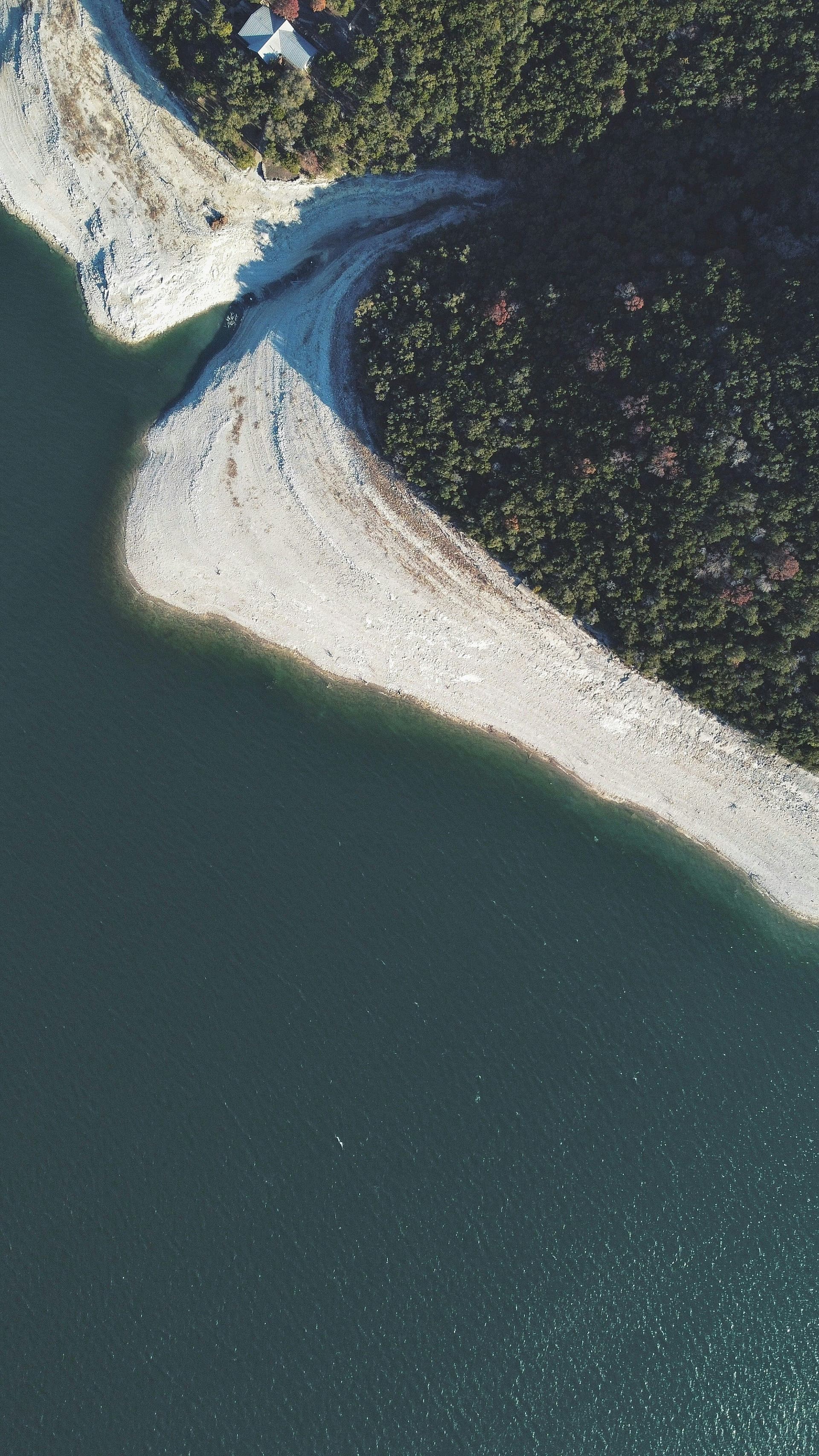 Aerial view of a reservoir shoreline with exposed banks, illustrating changing surface water levels and water resources